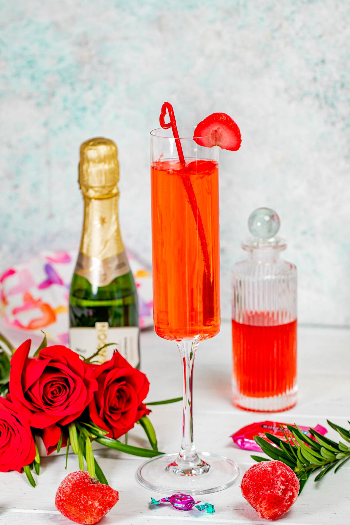 strawberry crush cocktail served into a champagne glass, garnish with a strawberry sliced