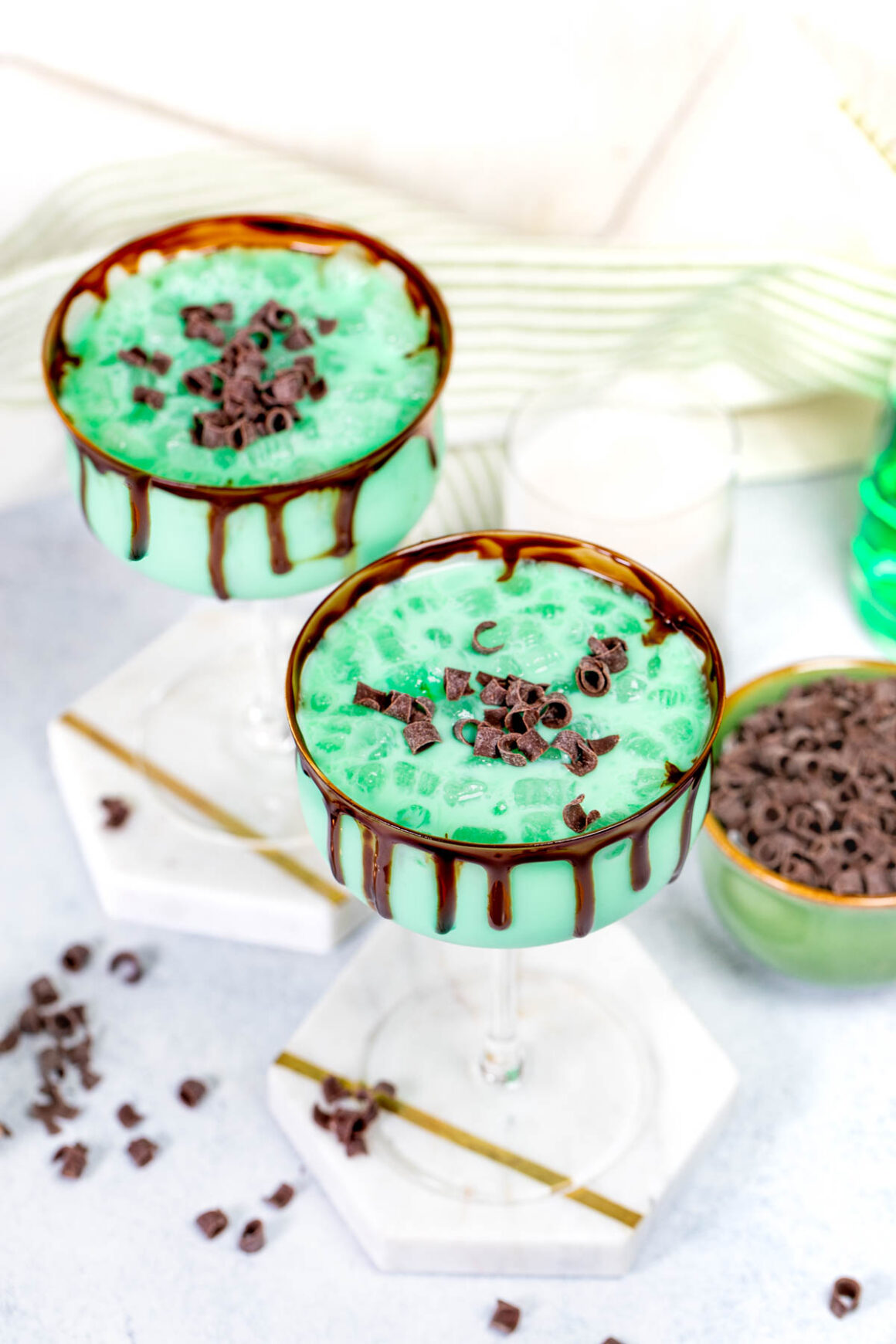 green martinis recipe with melted chocolate on the rim and chocolate curls as a garnish