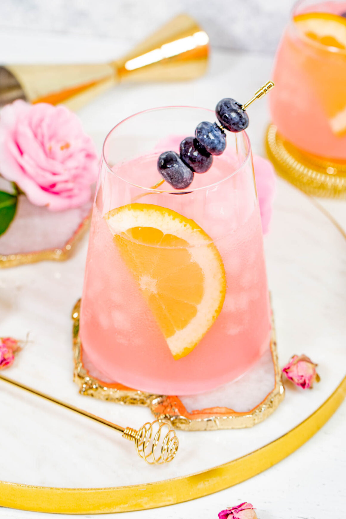 short glass with a rose color of spritz recipe