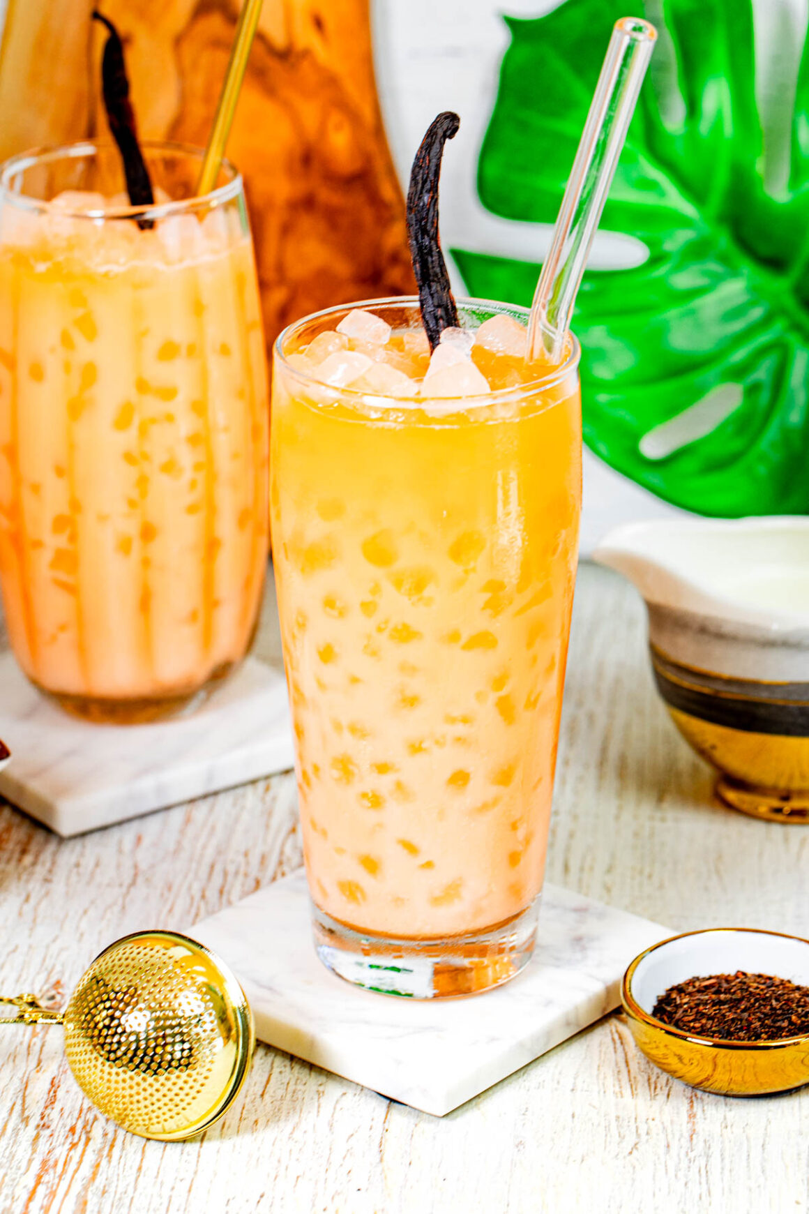 high ball glass with a orange drink with a thai iced tea