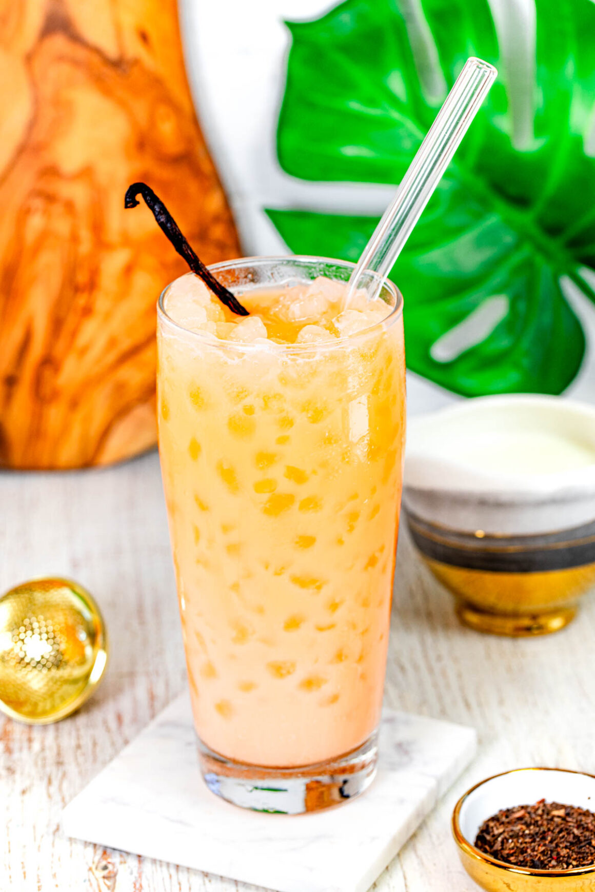 tall glass with a orange drink call thai tea