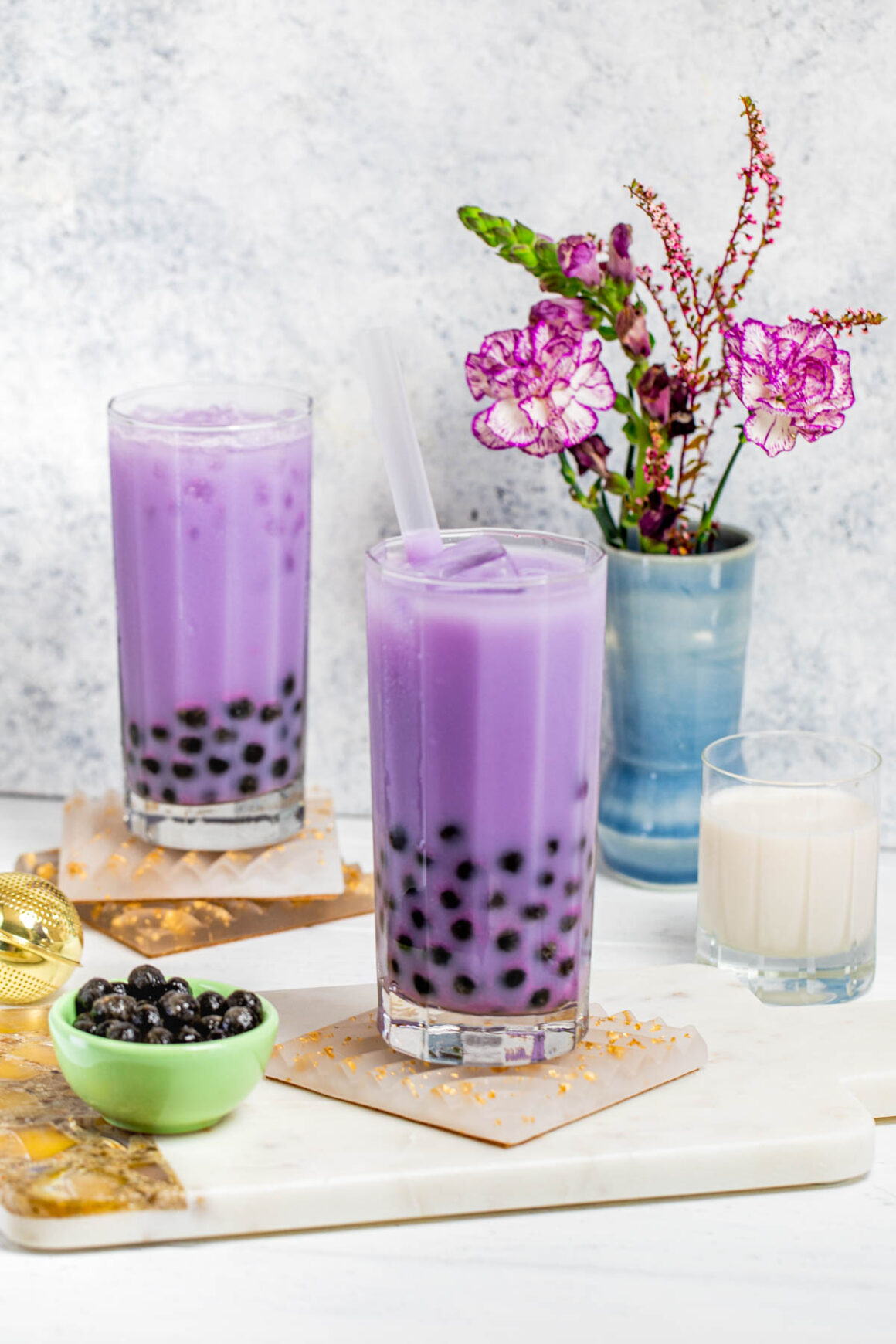 purple drink served into a tall glass with boba pearls on the botton