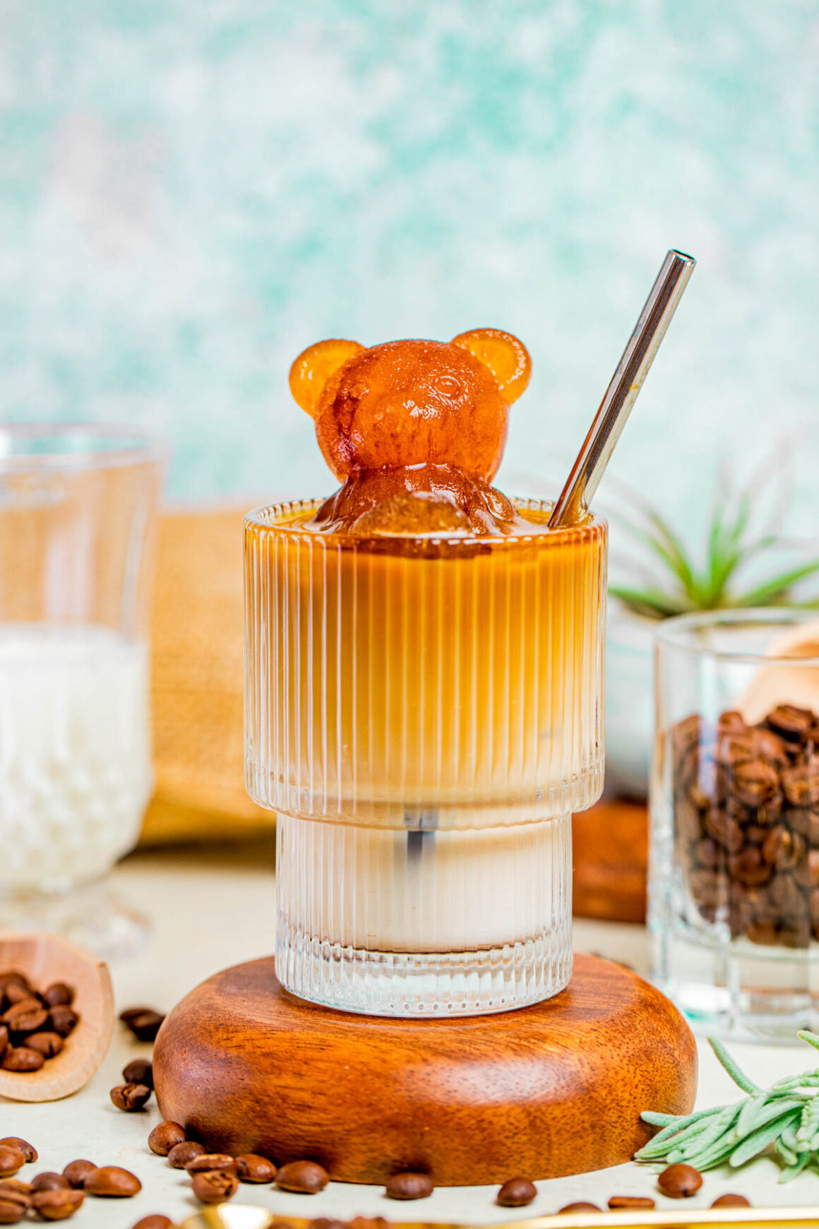 Short glass with a iced chai latte recipe with a bear shaped espresso on the top