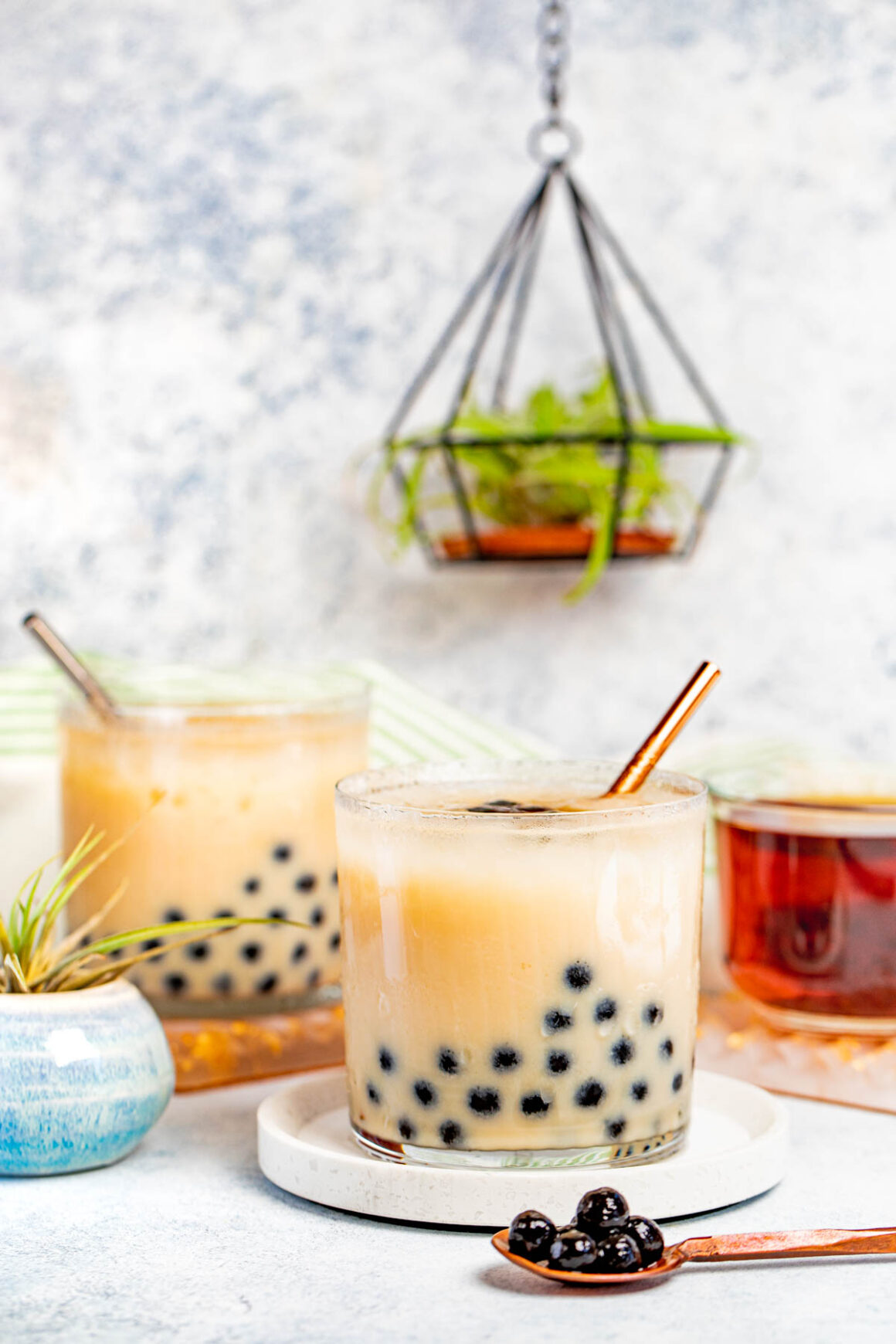 2 old fashion glasses with lychee boba tea 
