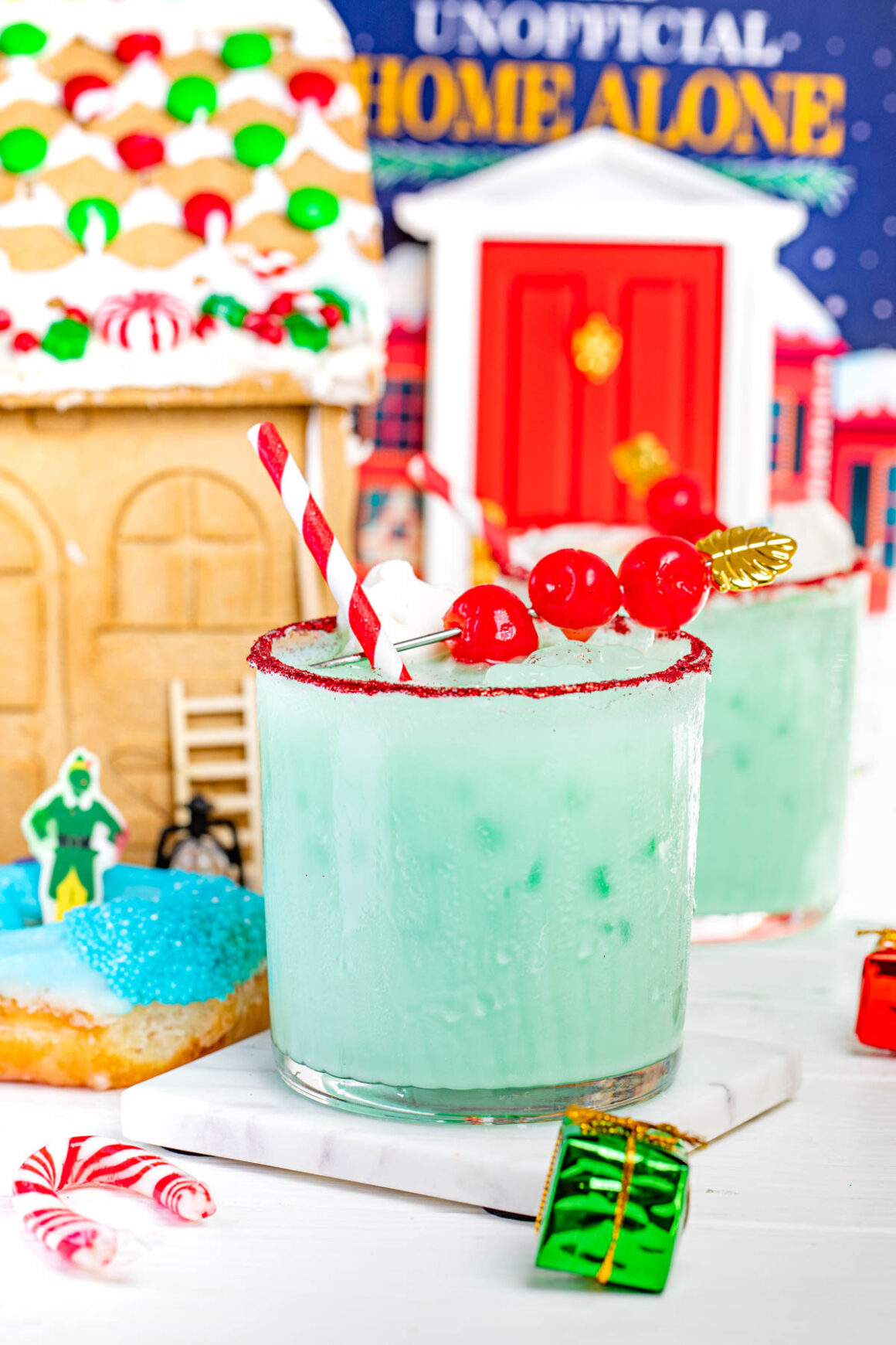 two grinch cocktail with a festive decorations on the background