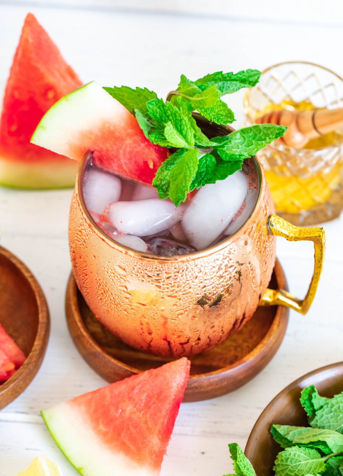 aerial view of a watermelon drink served in a copper mug garnished with a sprig of mint