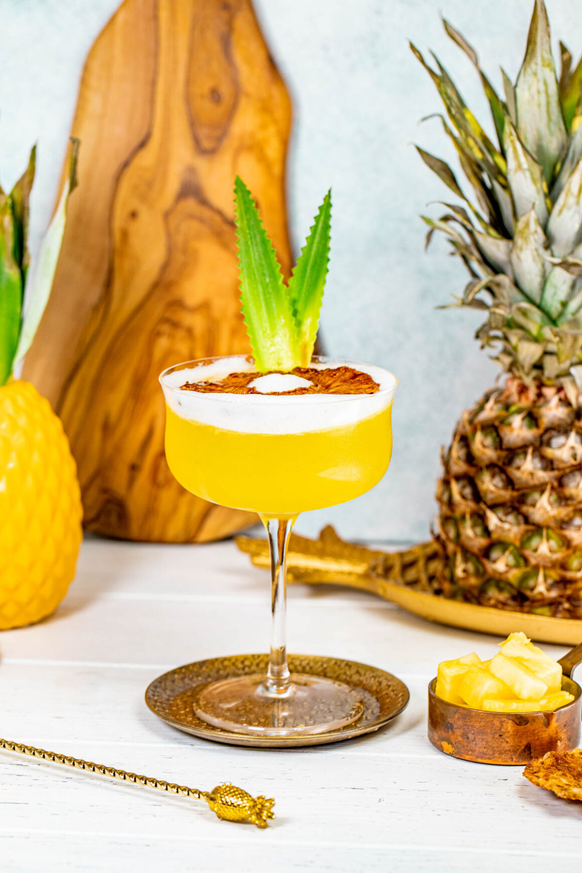 martini glass with a pineapple drink
