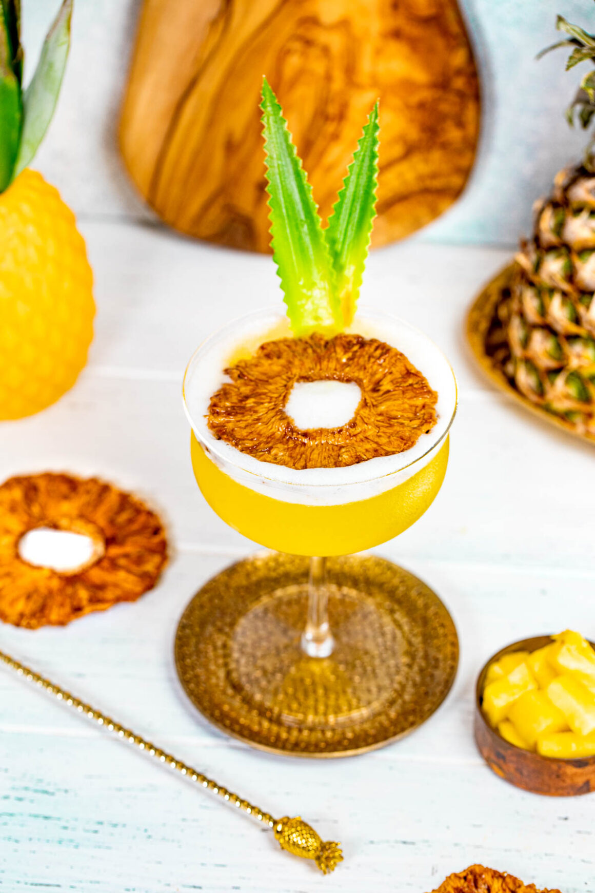 pineapple martini recipe with a dried pineapple as a garnish