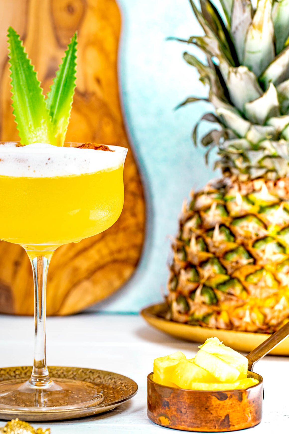 view of a half martini glass with a pineapple recipe