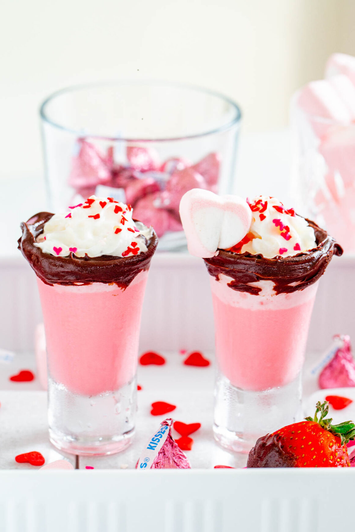 2 valentines pink drinks served in a shot glasses
